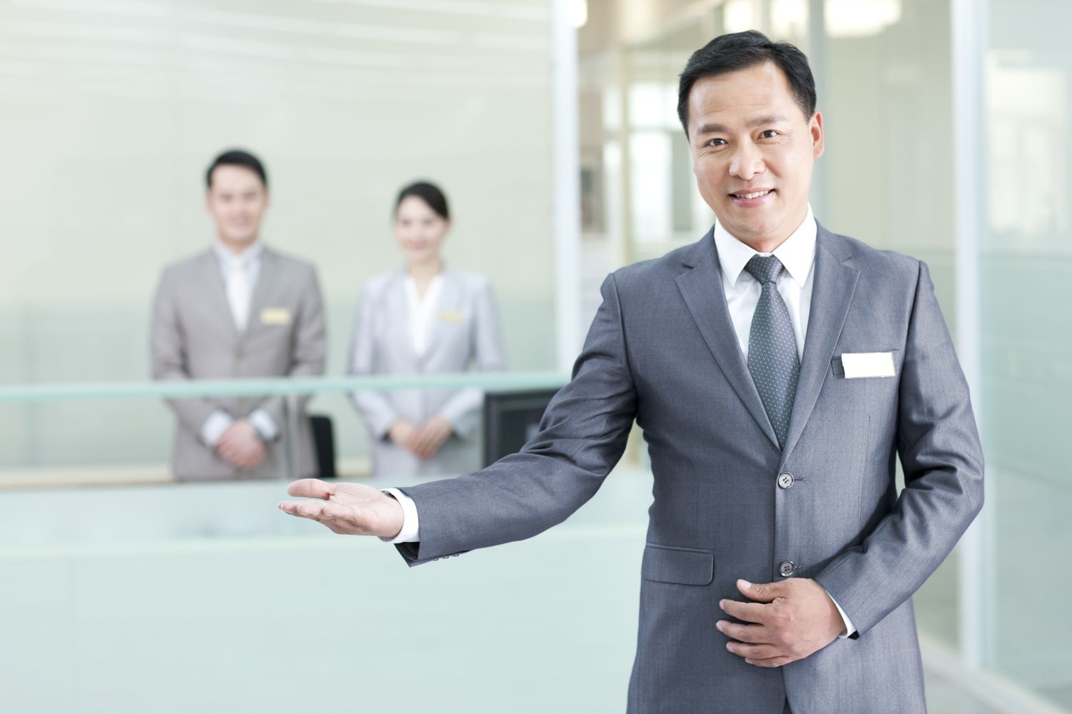 Businessman greeting at front desk, Beijing, China