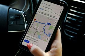 Woman's hand holding a mobile device showing google maps