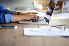 A woman using a laptop while working from home.