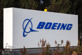 The blue Boeing logo is seen on a white sign.
