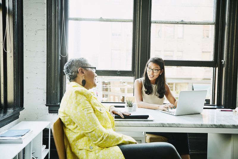 Businesswoman consulting with financial advisor in office