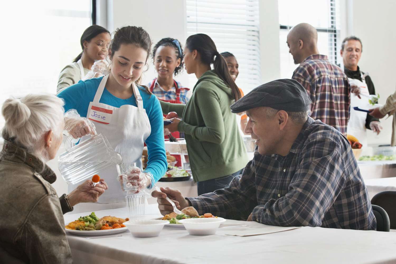 Volunteer serving food at community kitchen