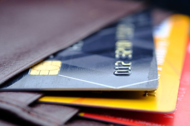 Credit cards in leather wallet on wooden background