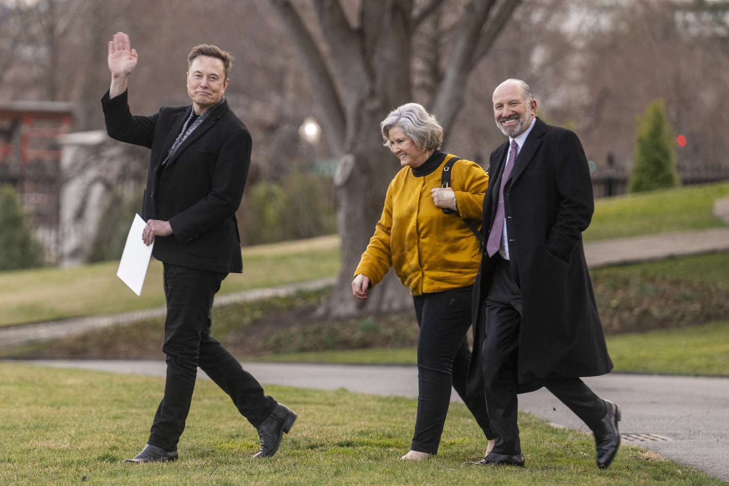 Tesla CEO Elon Musk (L) waves as he walks with US Secretary of Commerce Howard Lutnick (R) and White House Chief of Staff Susie Wiles (C) as they depart the White House in Washington, DC, on March 7, 2025.