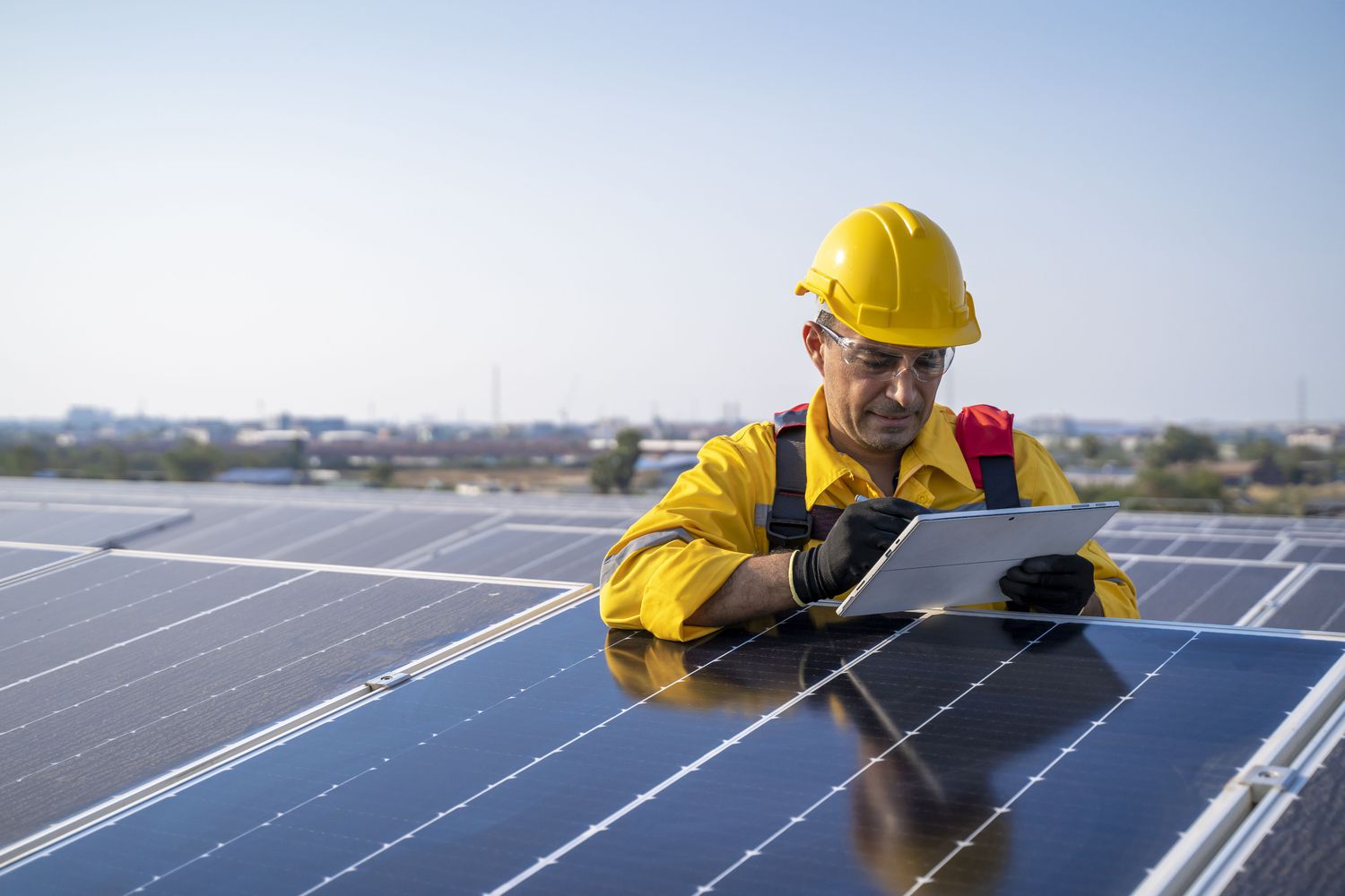 Engineer checking solar panels on a roof