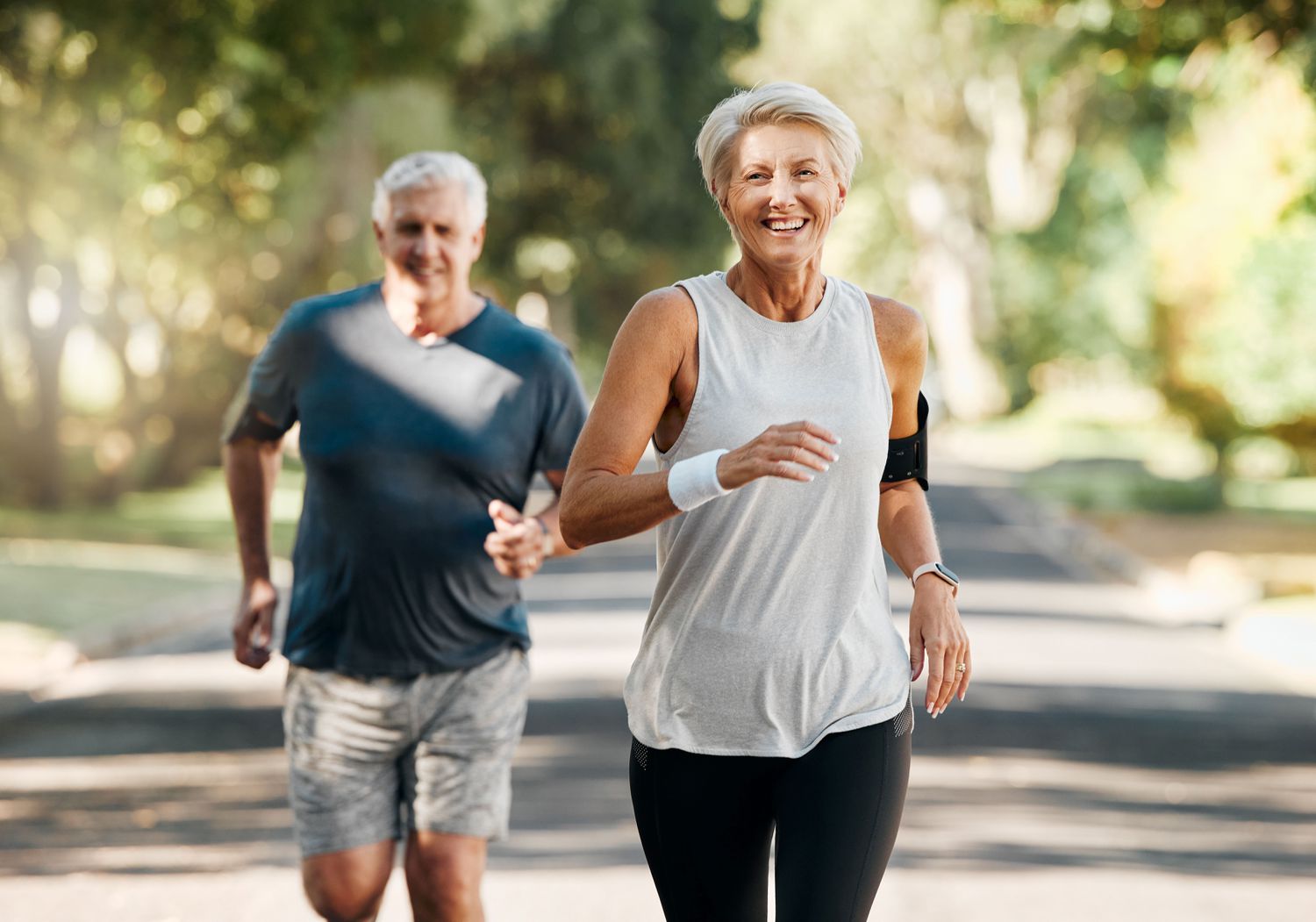 Two middle-aged people running outdoors