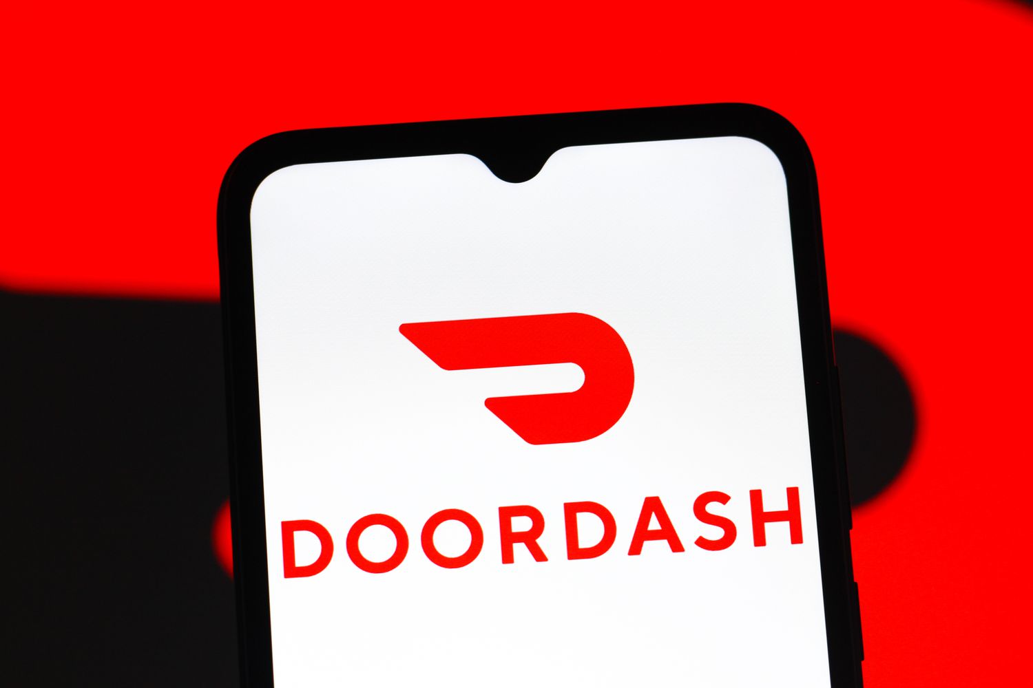 DoorDash logo is seen displayed on a smartphone screen