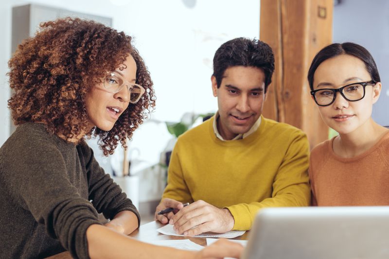 A couple reviews their finances with an advisor.