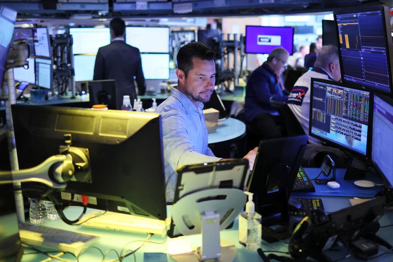 Traders work on the floor of the New York Stock Exchange