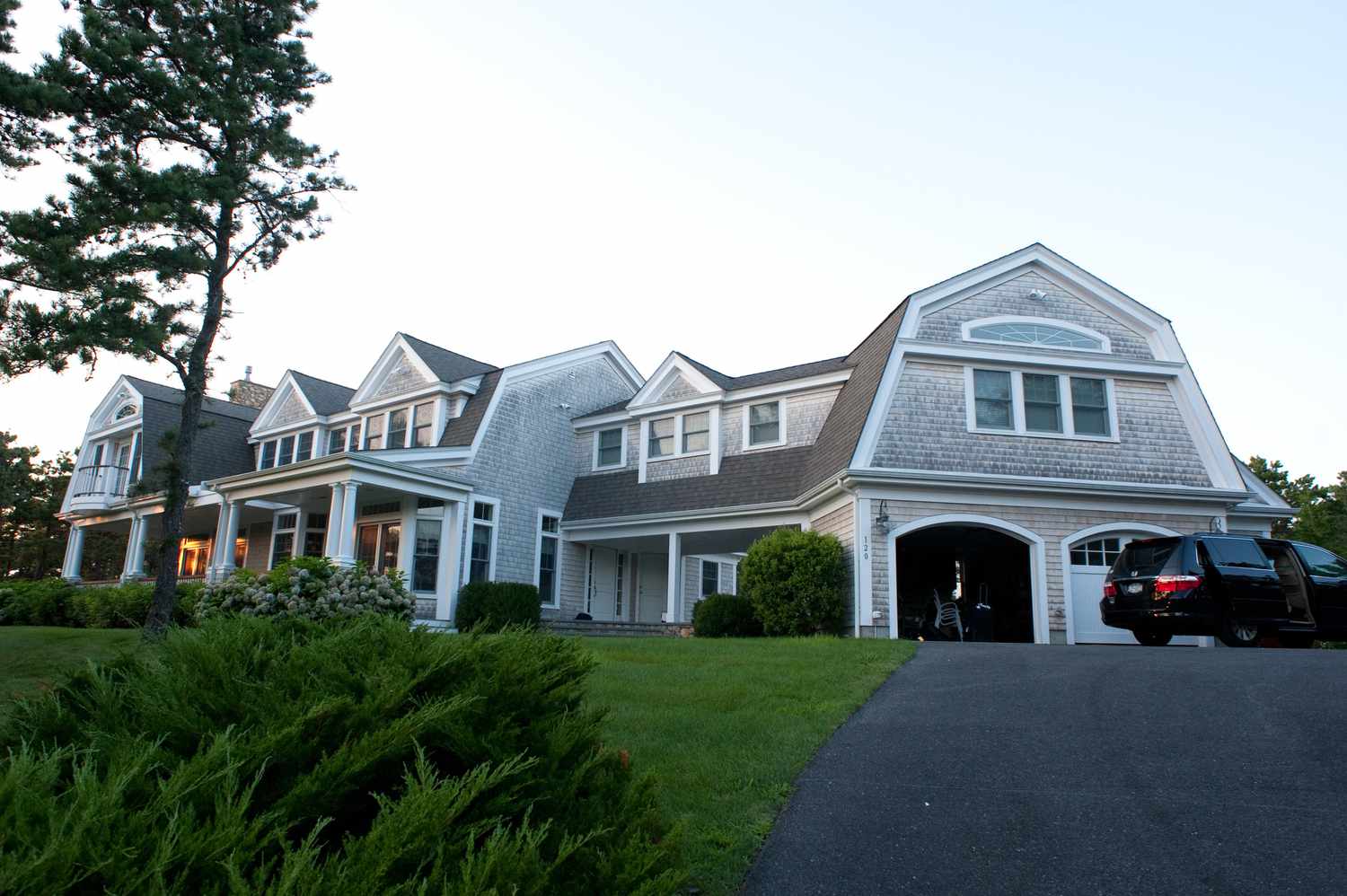 McMansions, typically with multiple garages, mix styles on a too-small lot