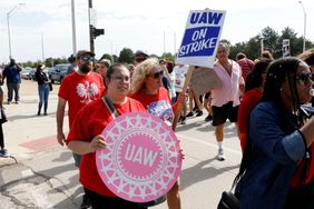 Black and White UAW picketers marching on strike