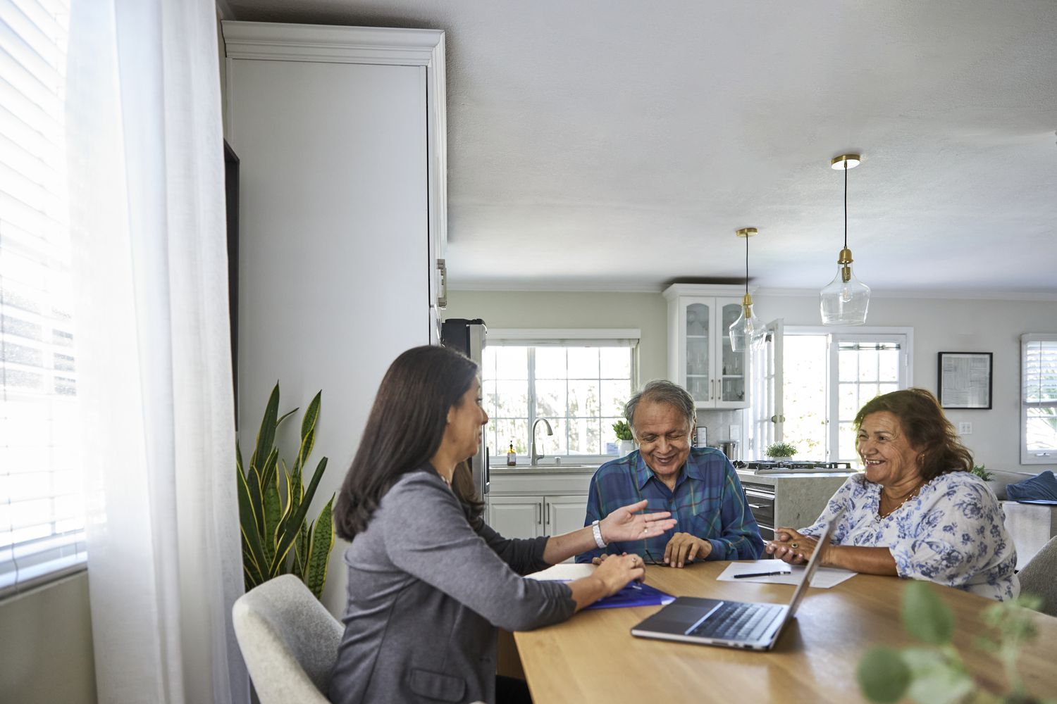 A senior couple getting counsel from financial advisor about their reverse mortgage net principal limit.