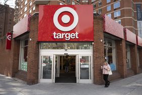 A person walks outside a Target store, with the company's red and white logo above the entrance.