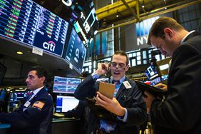 Traders work on the floor of the New York Stock Exchange (NYSE) ahead of the closing bell