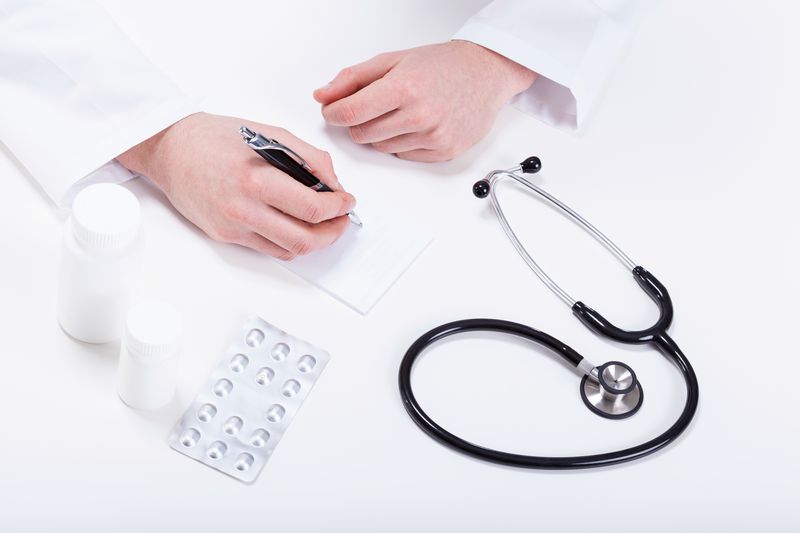 Doctor prescribing medicines to patient