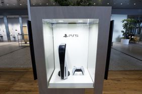 A PlayStation 5 (PS5) video game console and a controller on display at Sony's Tokyo headquarters.