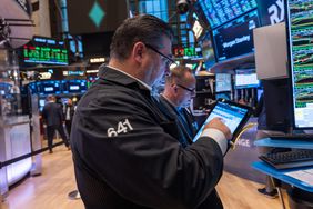 Traders and others work on the New York Stock Exchange (NYSE) floor on October 16, 2024 in New York City. 