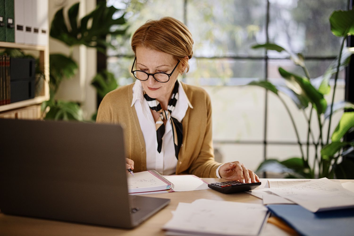 A woman with a computer and a calculator