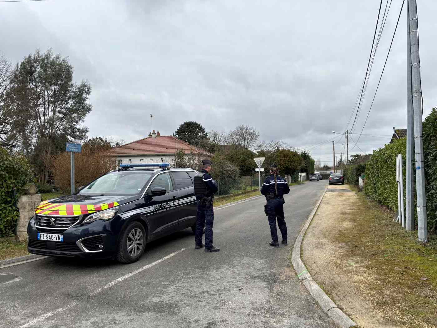 Two French police officers watch a street in Méreau, near Vierzon in France in January 2025.