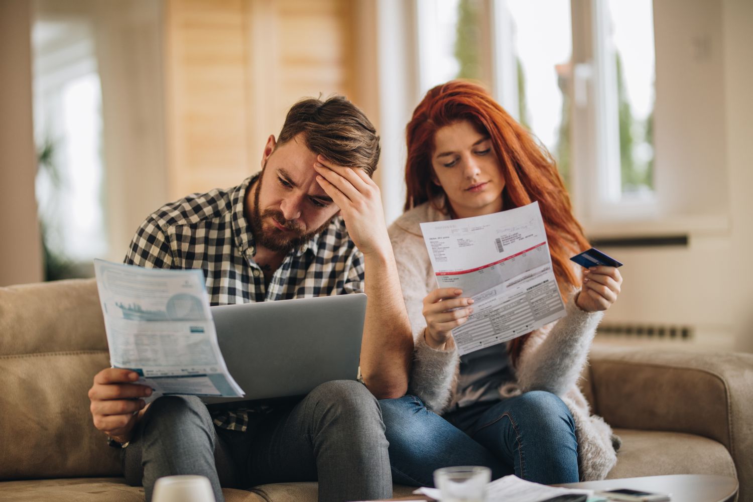 A couple looking at credit card statements