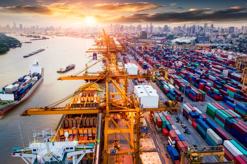 Logistics and transportation of container cargo ship and cargo plane with working crane bridge in shipyard