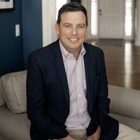 Jay Hummel sitting on an armchair in an entryway