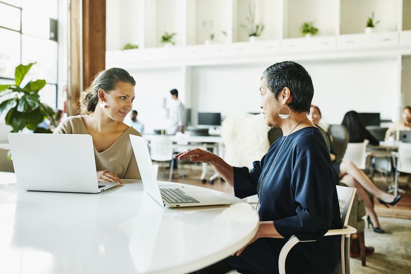 A financial advisor meets with a client at a cafe and explains the speculative nature of the Z-bond the investor wants to invest in as they seek higher bond yields.