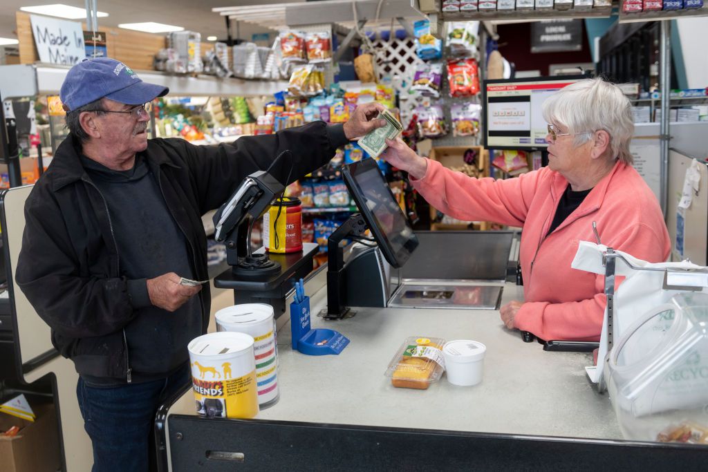 A man pays a cashier at Winter Harbor Provisions.
