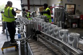 Cans of freshly canned beer move on an assembly line at The Can Van headquarters on February 19, 2025 in Sacramento, California.