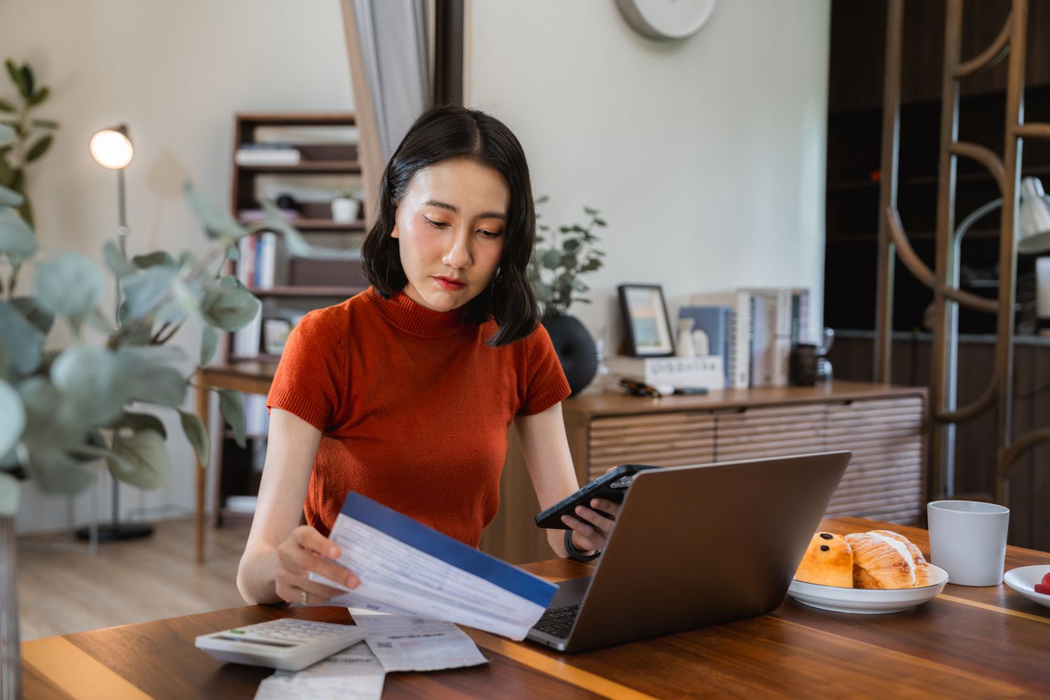 A woman with papers and a computer