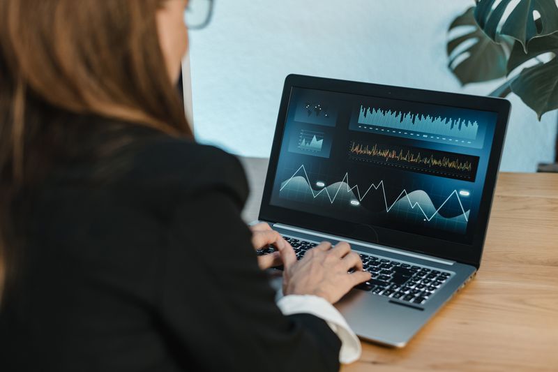 A trader uses a laptop to place stops on a super upside note they have on a long position they hold.