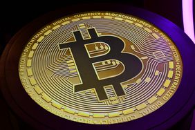 The Bitcoin symbol is displayed at a conference.