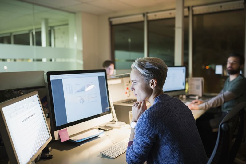 woman at desk looking at financial software