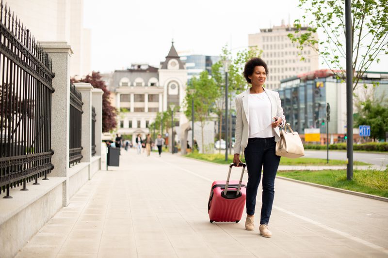 Tourist carries a suitcase.
