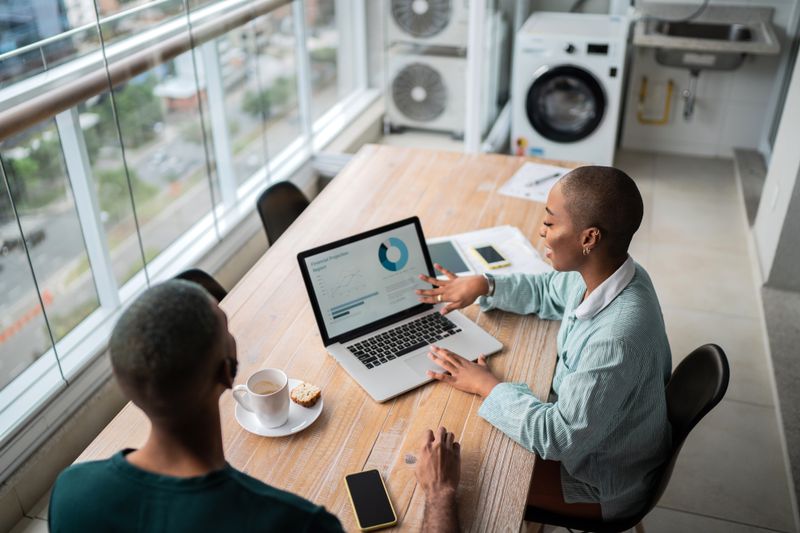 A Gen-Zer points to a portfolio on a computer screen.