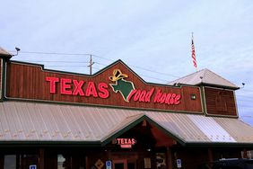 The neon sign at the entrance to a Texas Roadhouse restaurant. 