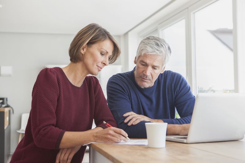 A couple reviews a document.