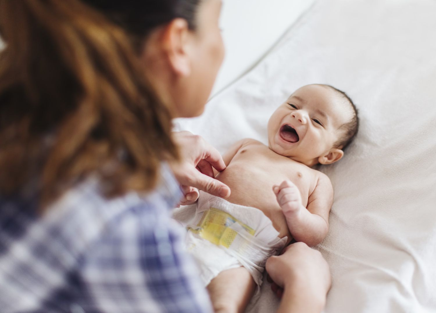 A woman tends to an infant.