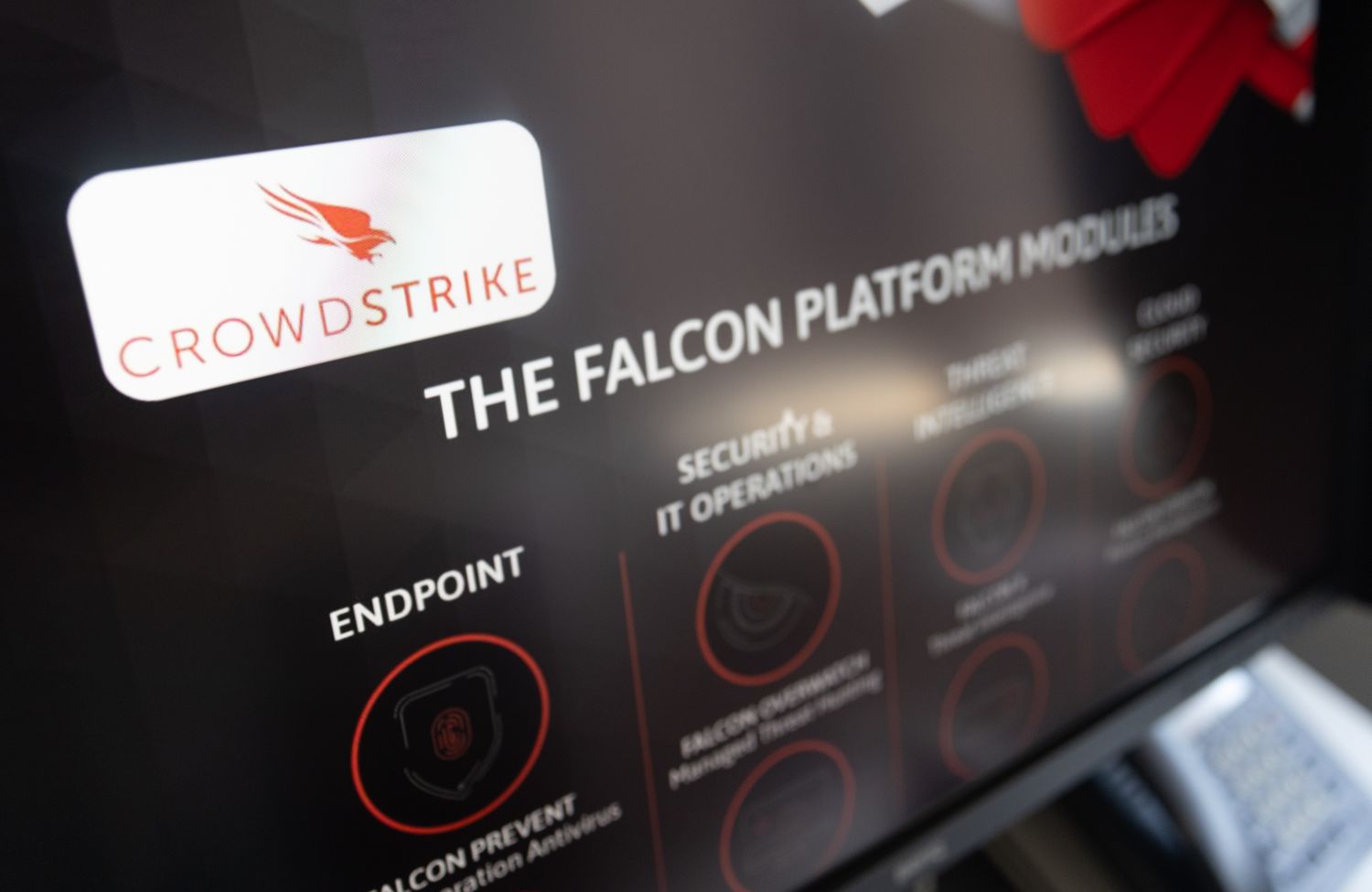 A screen displays the CrowdStrike logo.