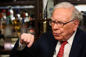 Warren Buffett talking and pointing a finger downward