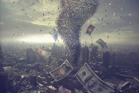 Tornado of money over cityscape.