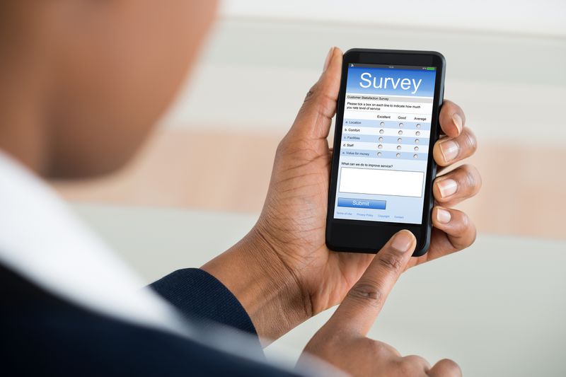 Save to Board Businesswoman Filling Survey Form On Mobile Phone