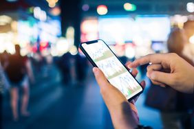 Person checking stocks on a smart phone.