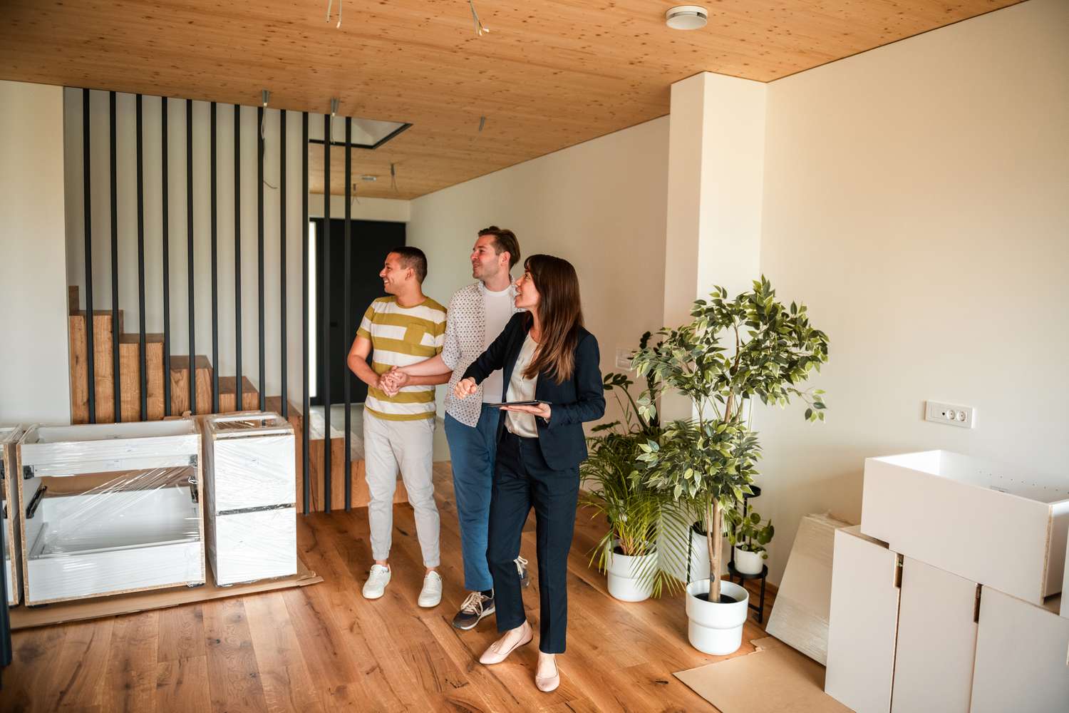 A real estate agent is showing a house to a couple who's ready to settle down and buy a home.