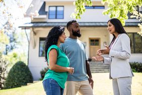 Couple Meeting With Real Estate Agent in Front of Home