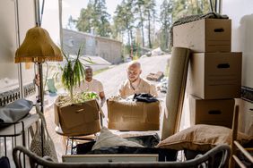 A member of the military gets help from a friend to load boxes into a moving van after getting resigned to a new base.