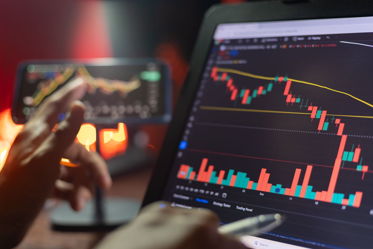 Person sitting at a desk with a computer screen showing current stock data