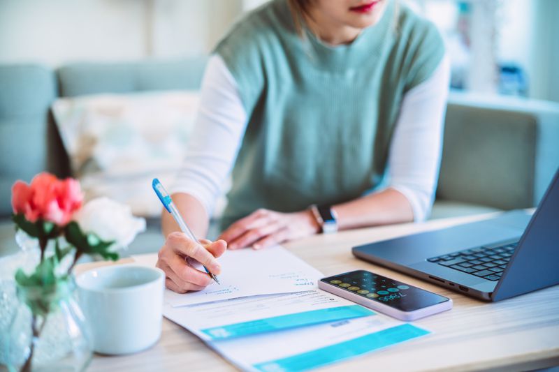Young woman sitting at desk, getting organized.