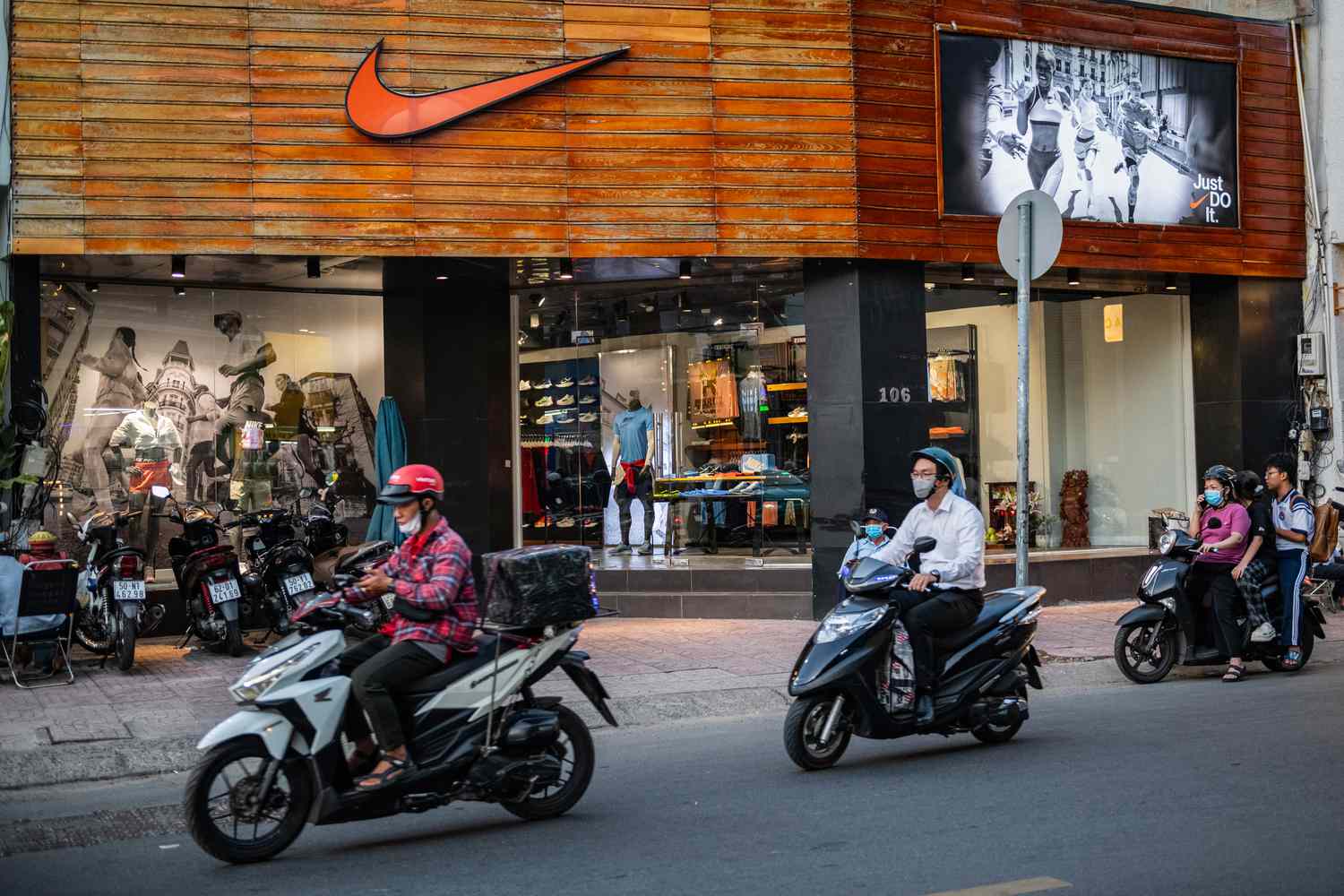 People ride motorbikes next to a Nike store on April 03, 2025 in Ho Chi Minh City, Vietnam.