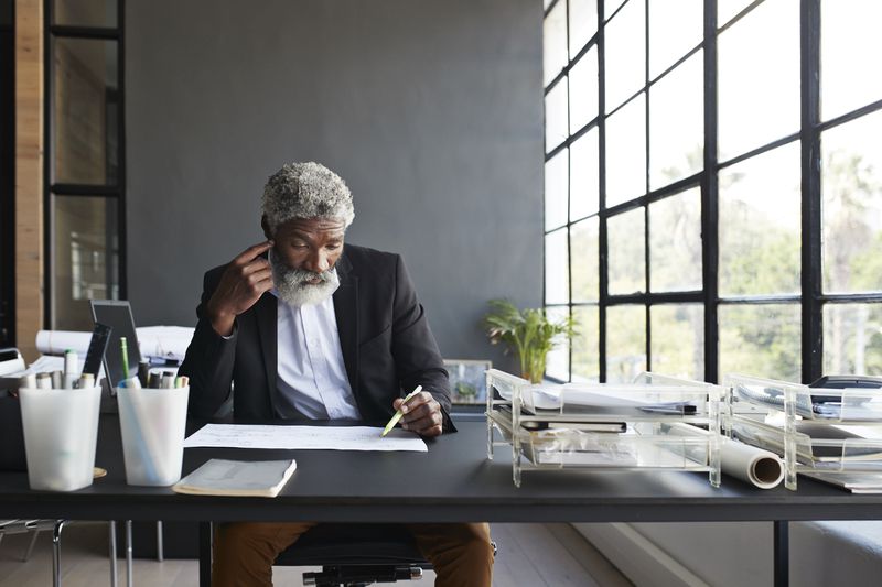 Man looking over papers to compare between payday loan and personal loan.